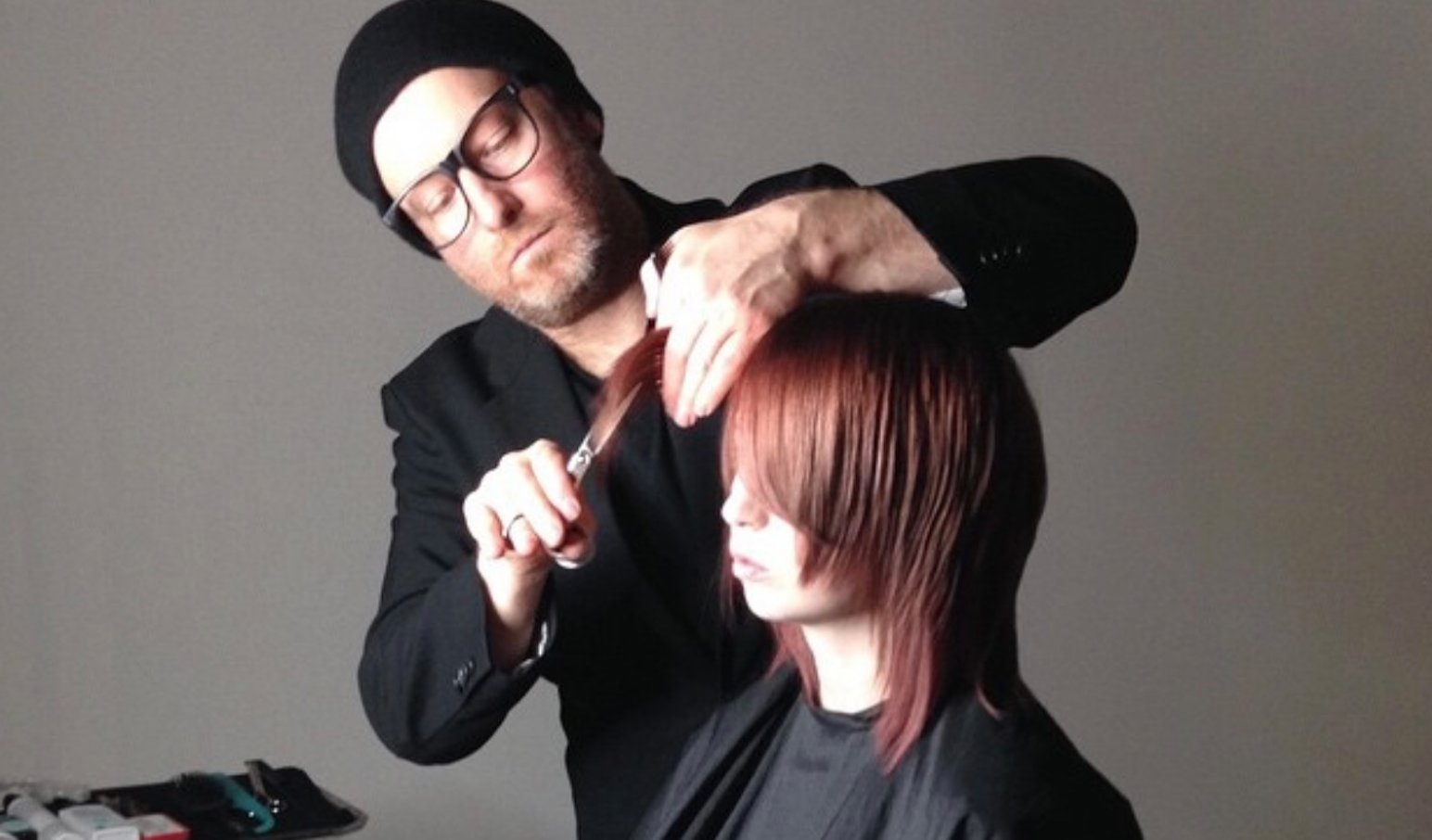Stylist Charlie Prices cuts a models hair